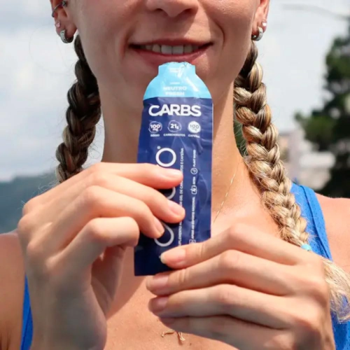 Atleta segurando um gel de carboidrato para hidratação durante o treino ou corrida