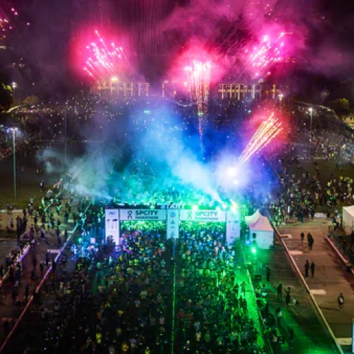 Corredores concentrados na largada de uma prova de corrida organizada pela Iguana Sports, com destaque para a Praça Charles Müller, no Pacaembu